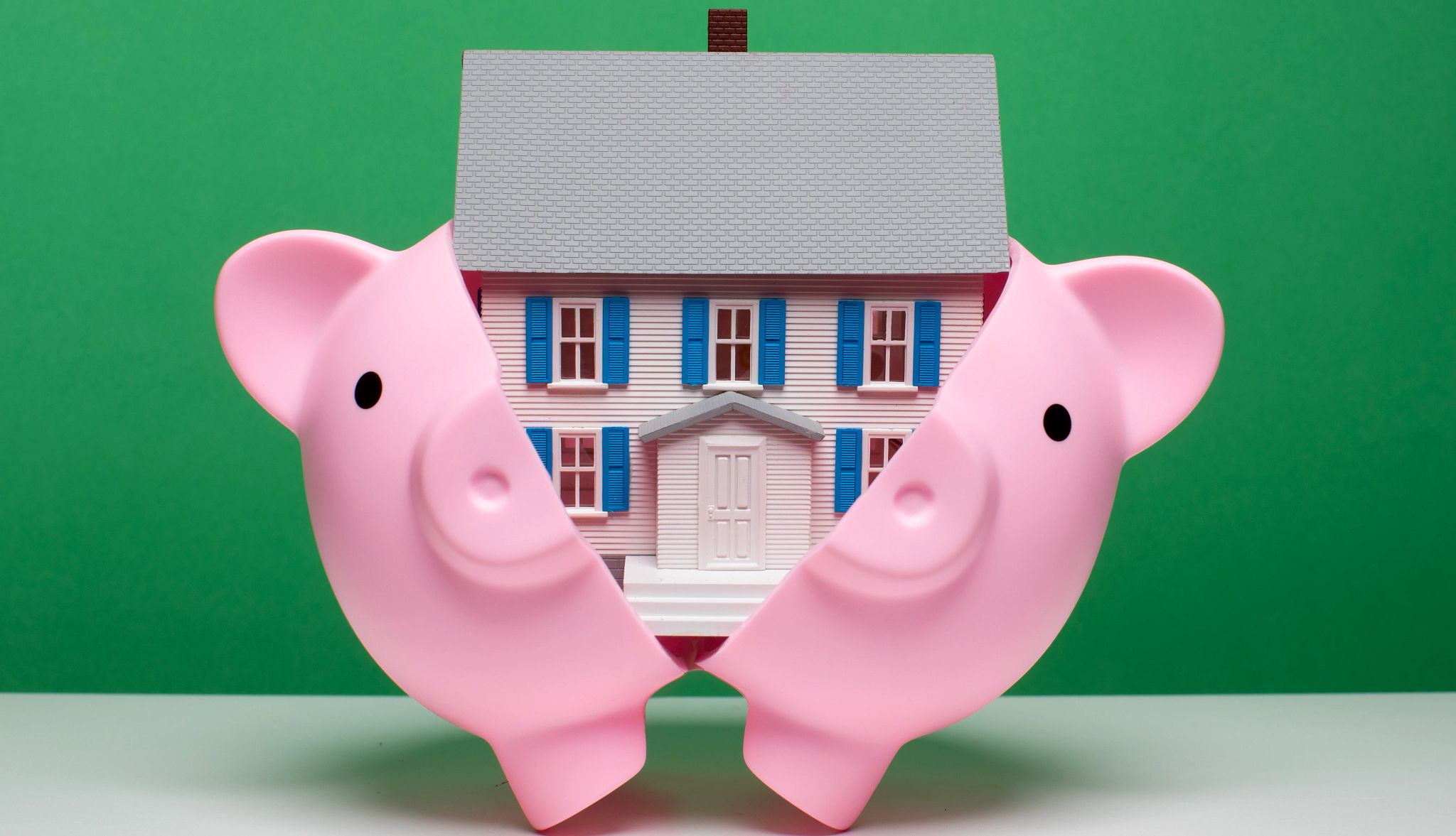 New Law Limits Barrage of Scams Targeting Homebuyers a piggy bank with a home coming out of the middle