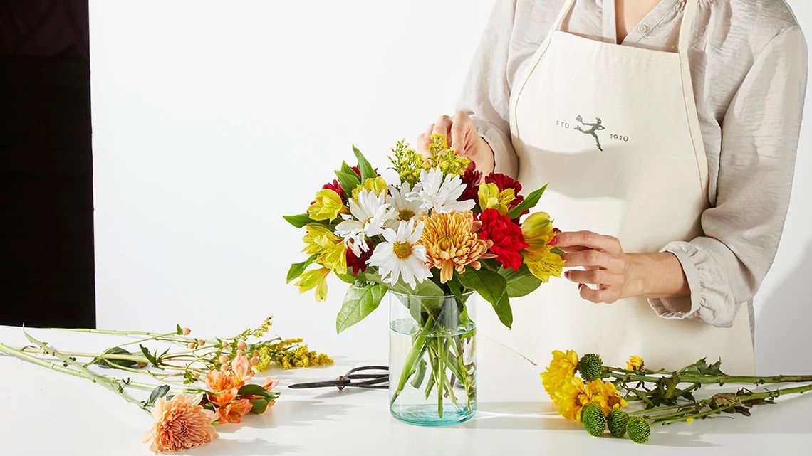 FTD staff member putting together a bouquet