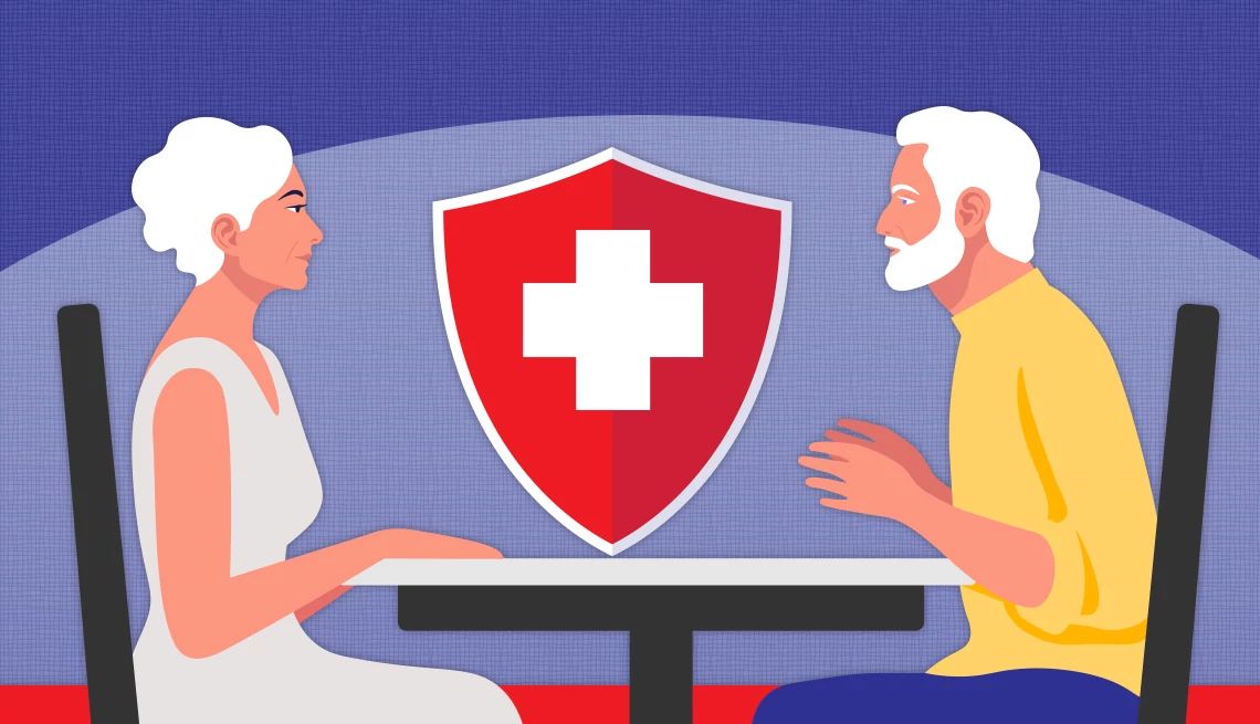 couple sitting at table with healthcare shield behind them