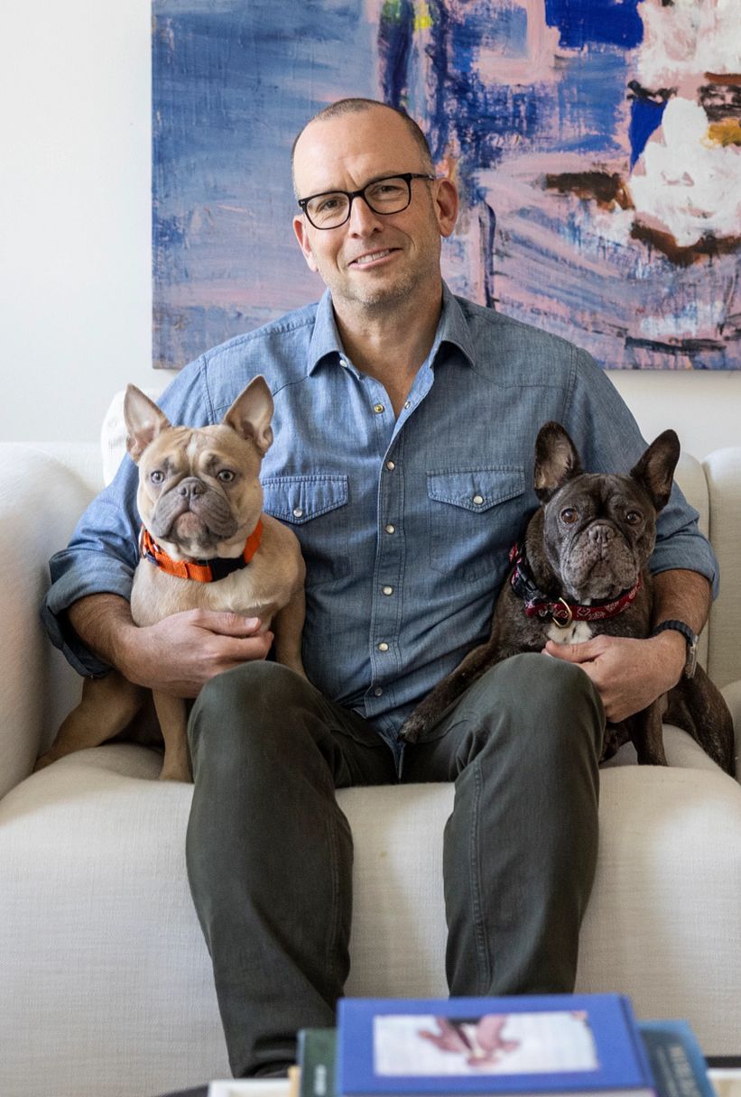 Paul Ollinger paul ollinger sits on a couch with two dogs