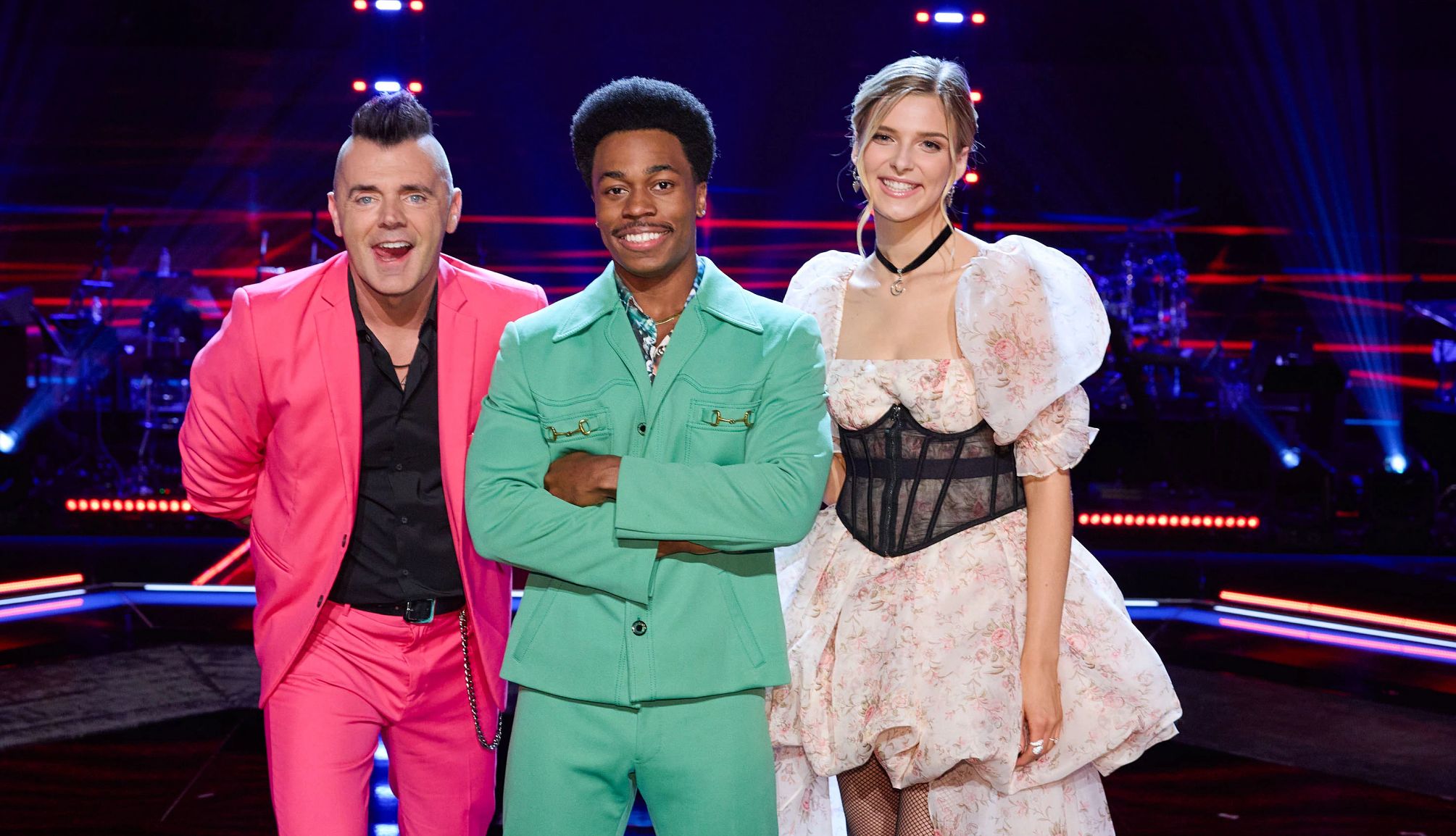 The Voice contestants Bryan Olesen, Nathan Chester and Zoe Levert standing together onstage
