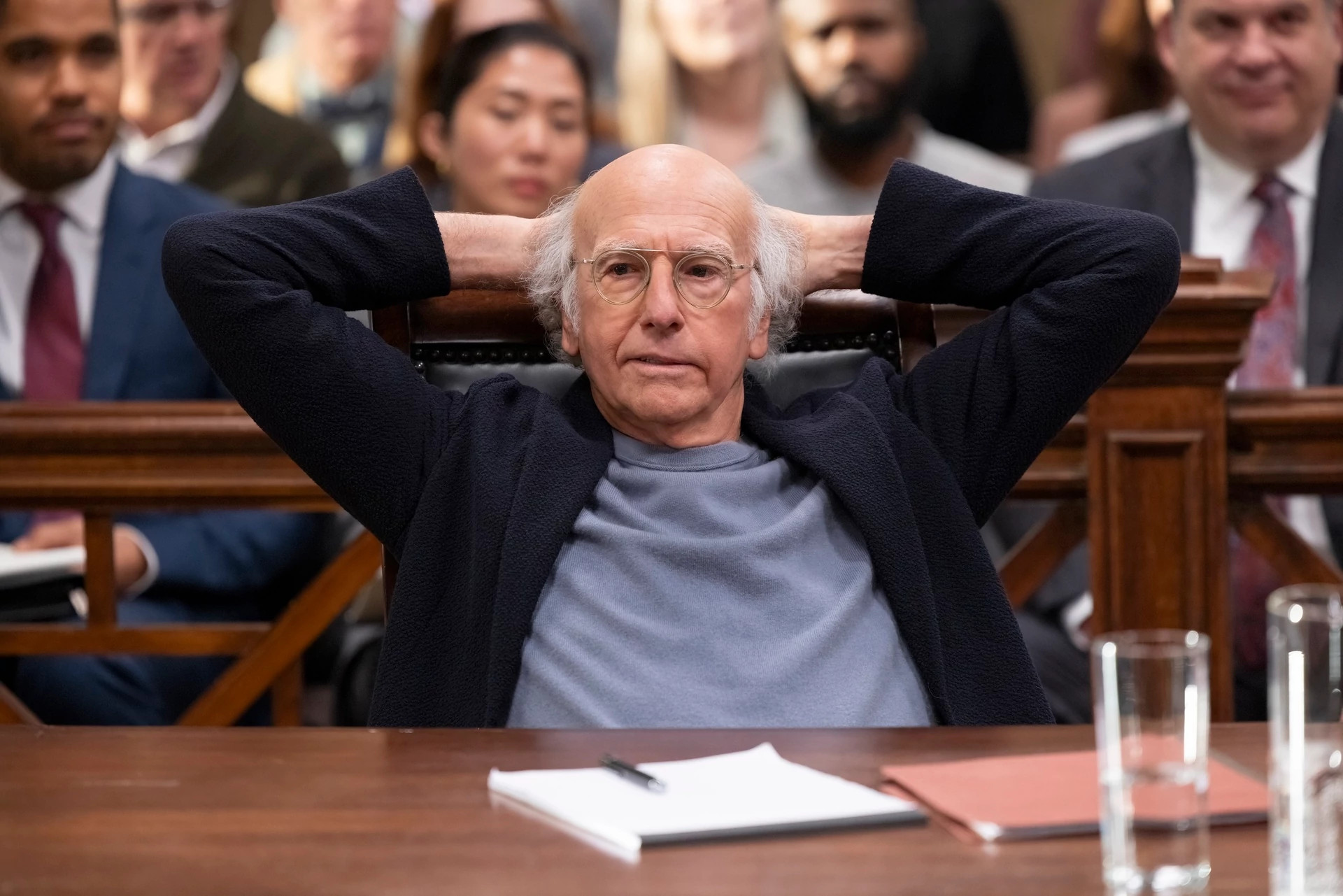 Larry David places his hands behind his head in the HBO series Curb Your Enthusiasm