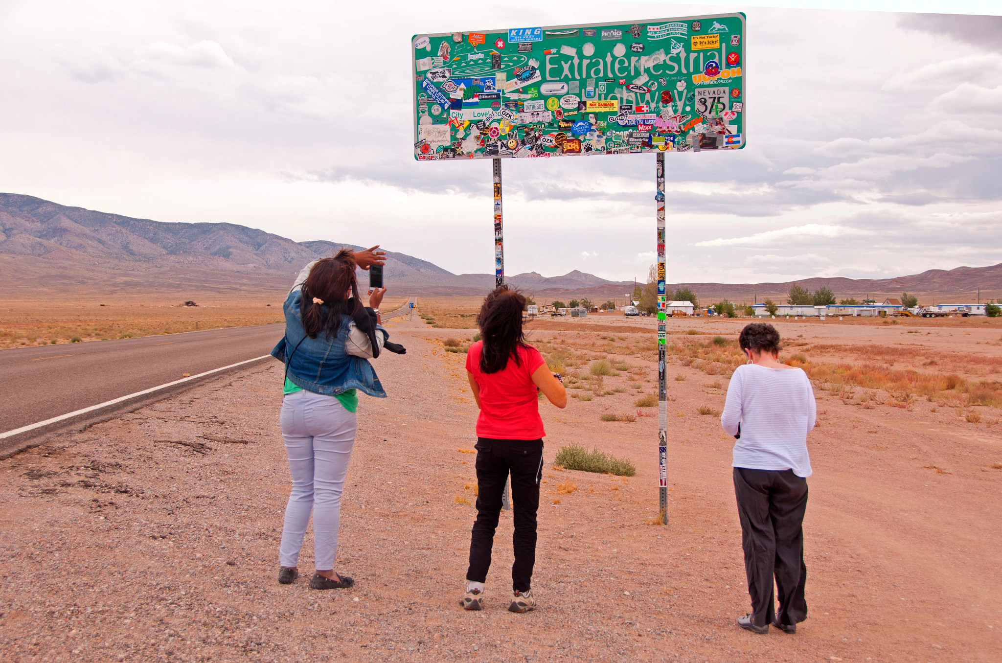 Tourists taking photographs of Extraterrestrial Highway 375 Nevada.
