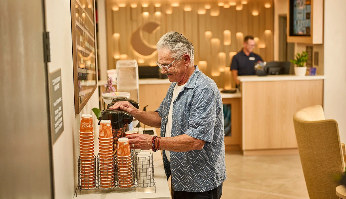 Man pouring coffee at a hotel lobby