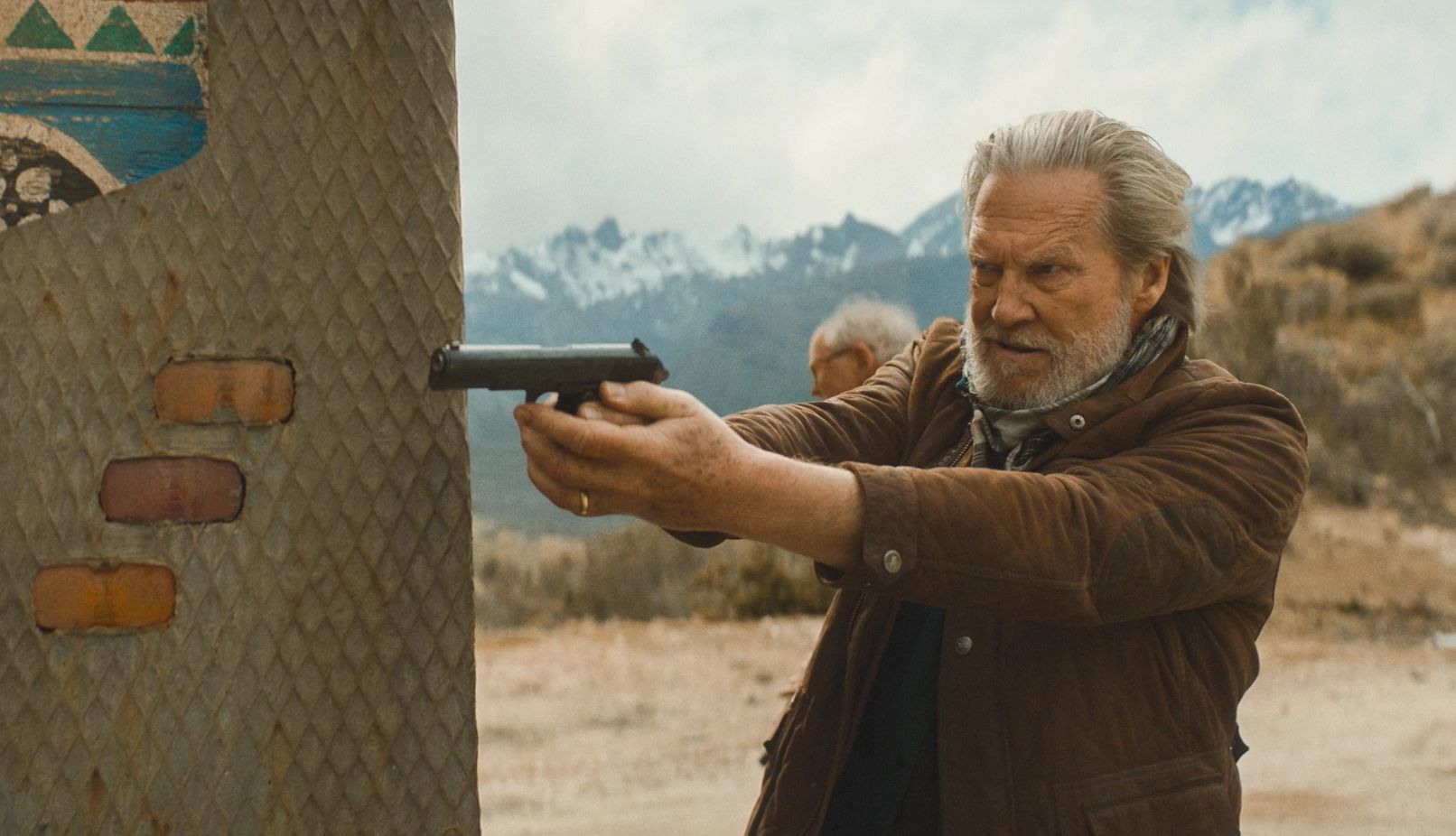 Jeff Bridges in The Old Man Jeff Bridges pointing a gun in a scene from the FX series The Old Man