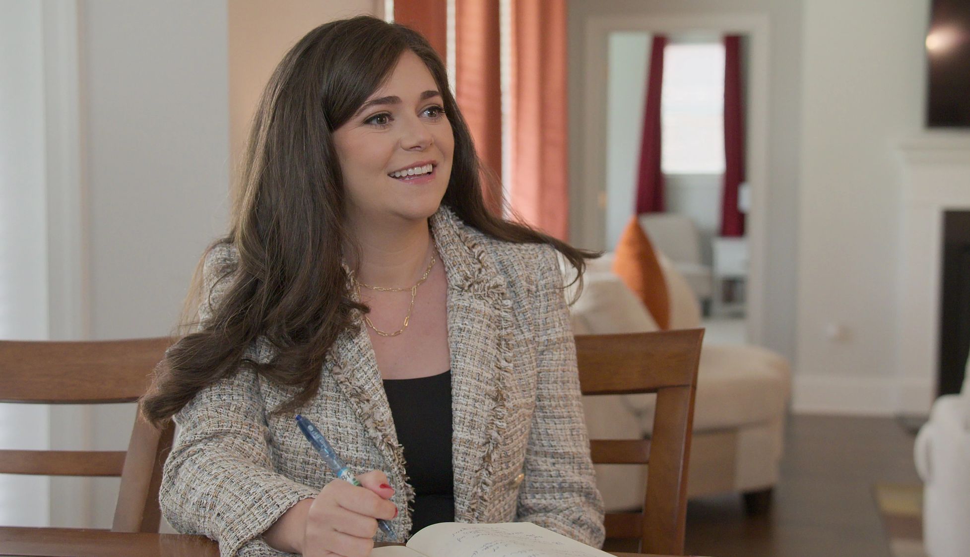 Logan Ury in 'The Later Daters' a woman sits at a table and writes notes