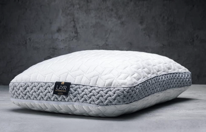 The Luxome LAYR Customizable Pillow against a dark background.