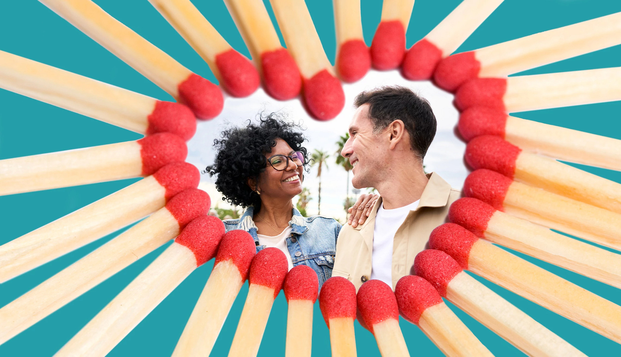 Two older adults standing close together and looking at each other, framed within a heart shape formed by red-tipped matchsticks against a teal background