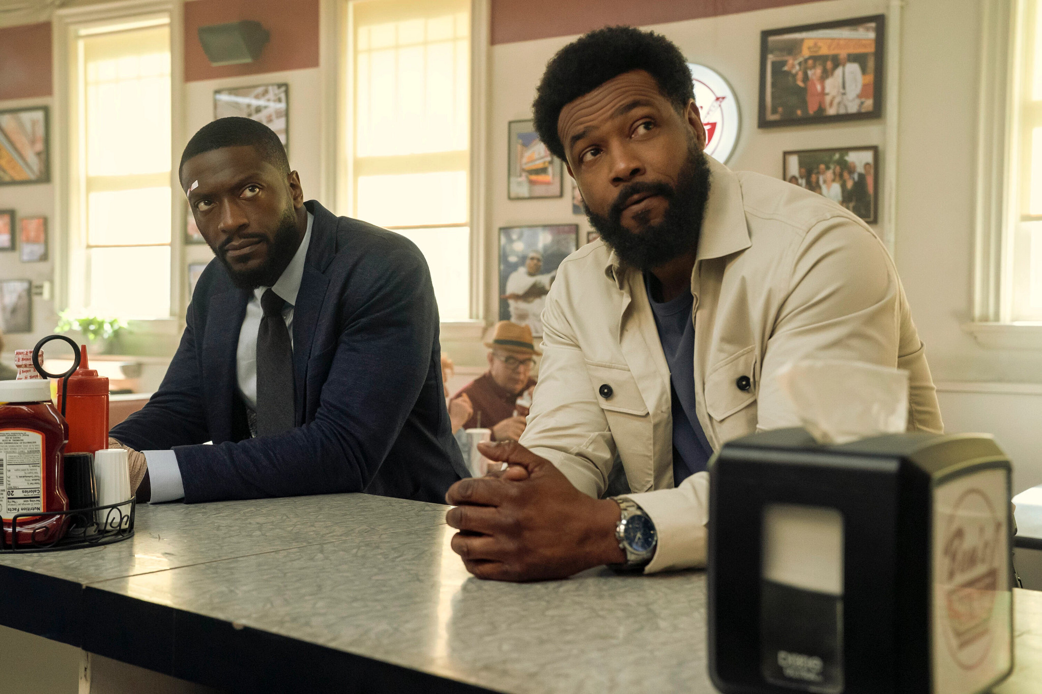 aldis hodge and isaiah mustafa in a scene from cross