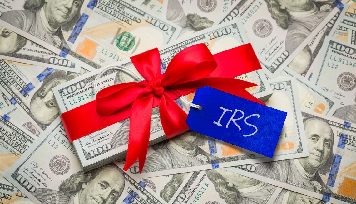Gifting grandchildren money a pile of money with a red ribbon around it and a blue tag that says i r s