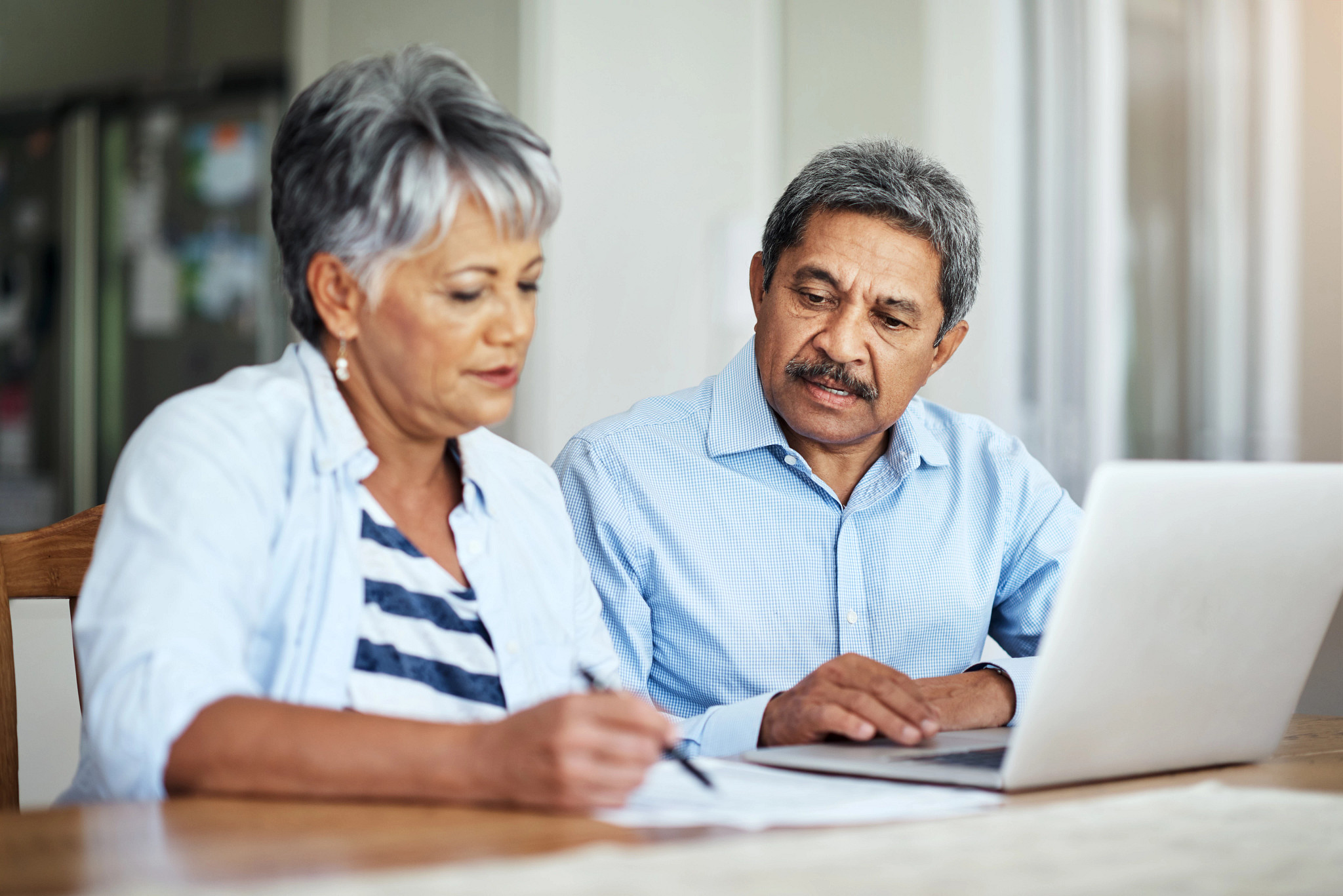 Cropped shot of a senior couple using a laptop to do their household budget.