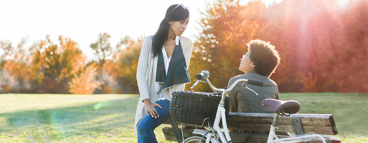 two women best friends having serious conversation outside