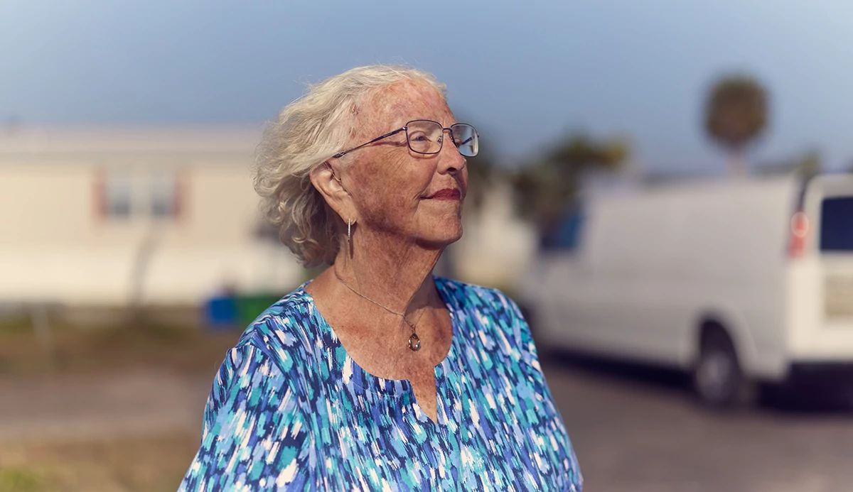 Older lady in a blue blouse