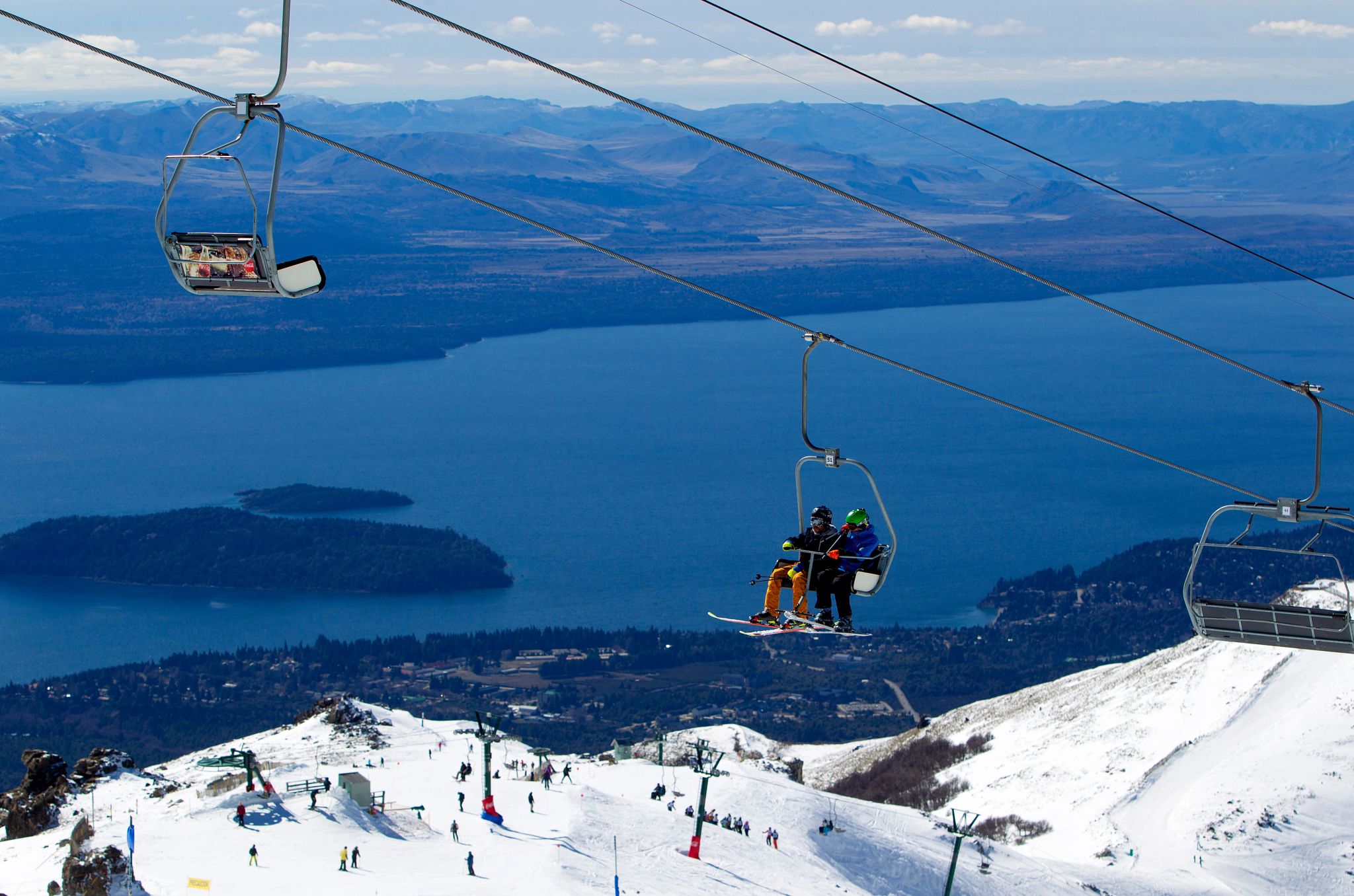 Catedral Alta Patagonia Argentina people riding a ski lift on a snowy mountain