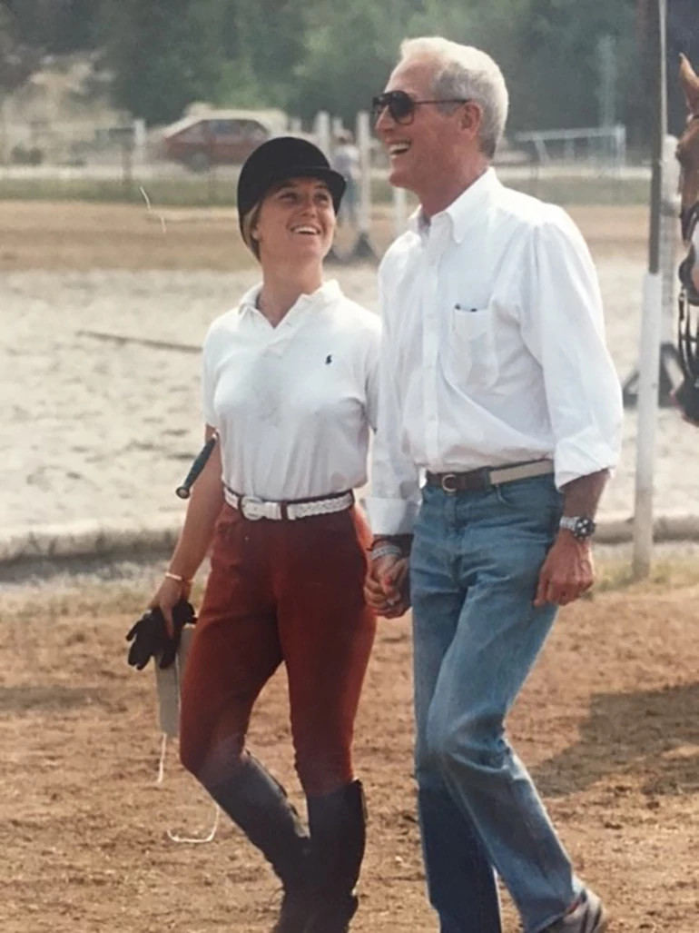 clea newman in riding clothes, walking beside paul newman