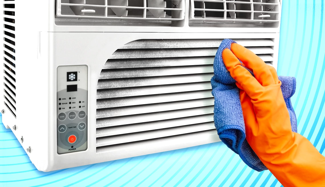 air conditioner maintenance tips a person wiping down a dirty air conditioner