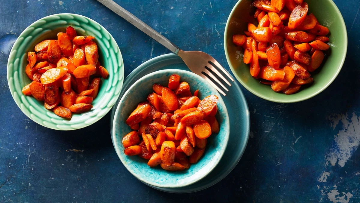 An overhead view of maple roasted carrots in bowls