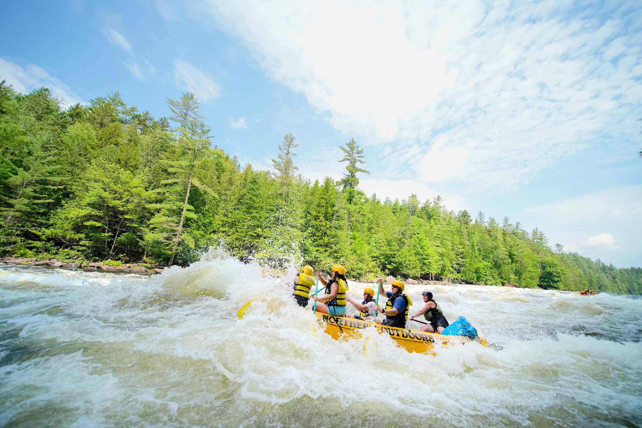a group of people whitewater rafting