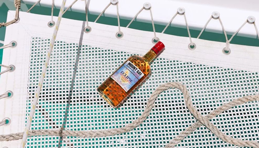 Barbados has producing rum for centuries a bottle of Mount Gay on a catamaran boat
