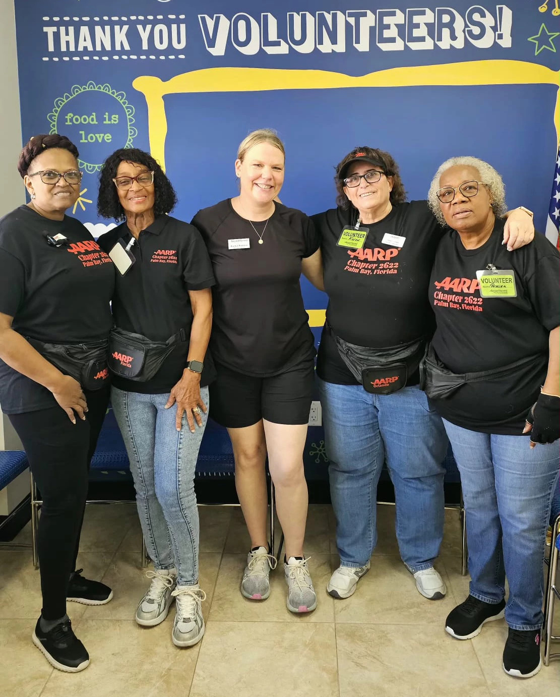 Karen takes group photo with other aarp florida volunteers