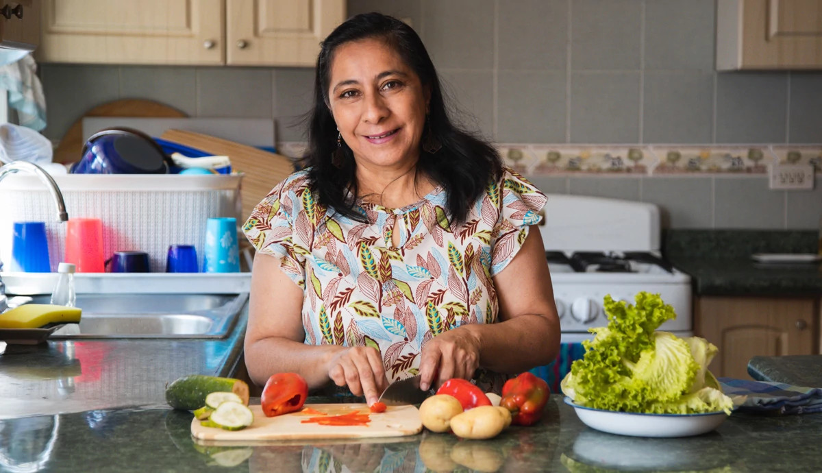 Woman in kitchen smiling
