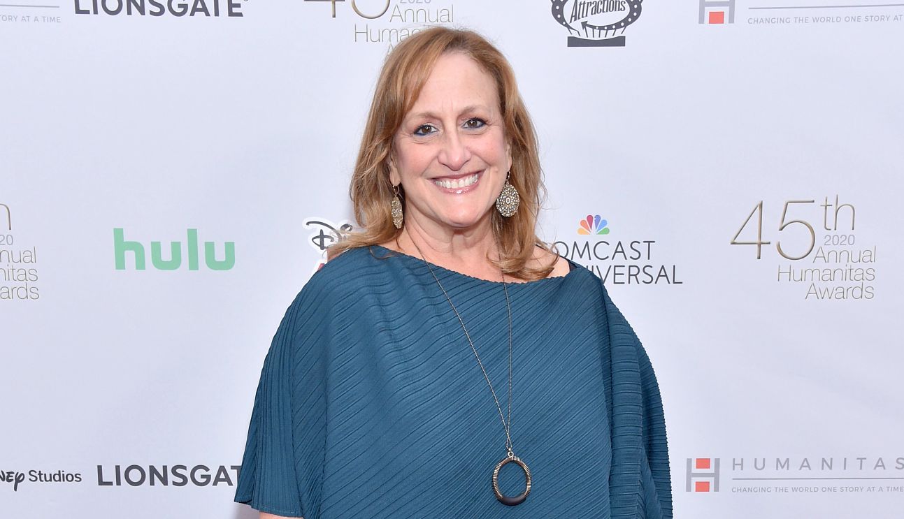 Cindy Chupack is a former TV writer Cindy Chupack smiling, standing in front of a TV promo billboard