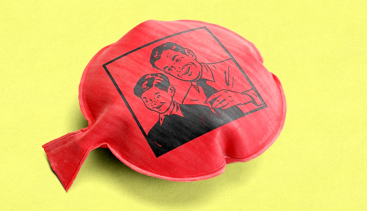 a whoopie cushion is shown on a yellow background. On the whoopie cushion is a 1950s style illustration of a father sharing a laugh with his son