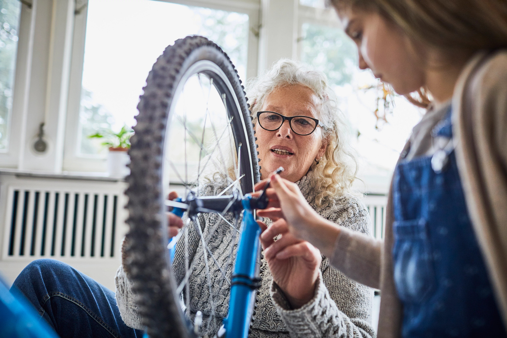 woman repairing bike wheel