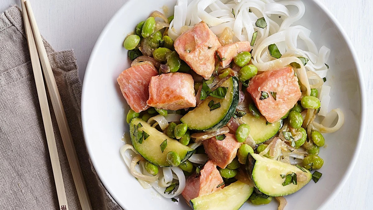 A close-up view of salmon stir-fry with miso butter on a plate