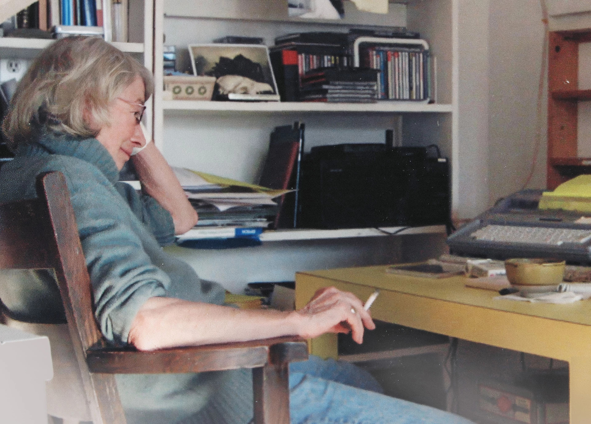 Poet Mary Oliver seated at a typewriter