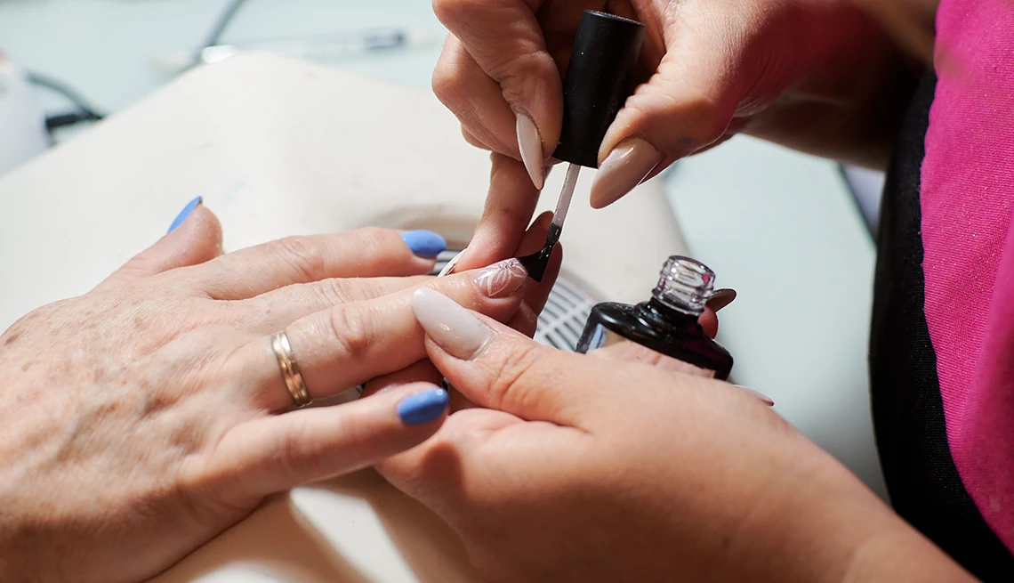 A customer getting their nails done at a nail salon