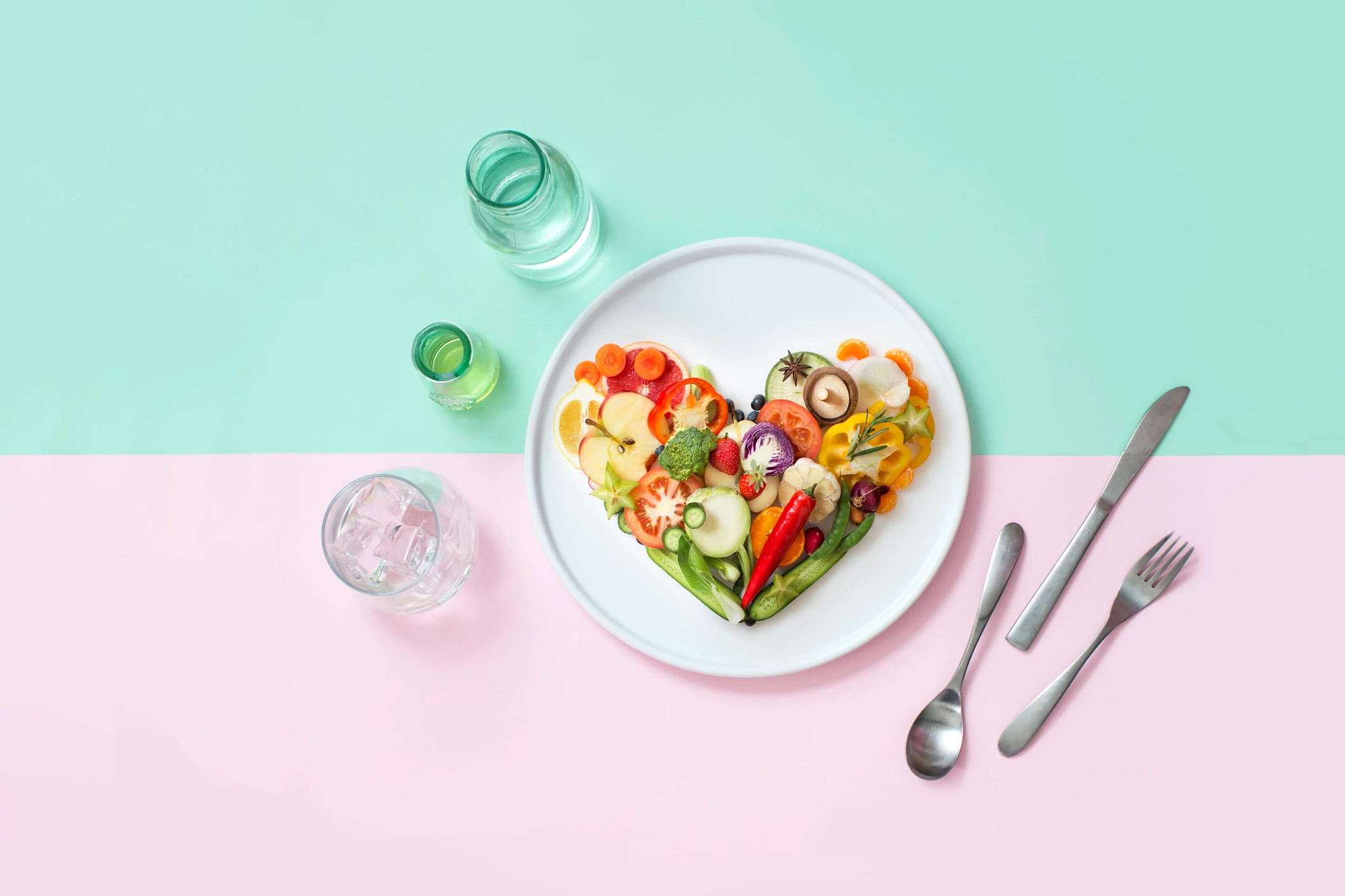 Flat lay sliced vegan food form in heart shape served on pastel background.