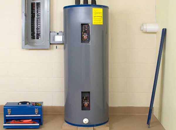 Image of a hot water heater with an open tool box beside it.