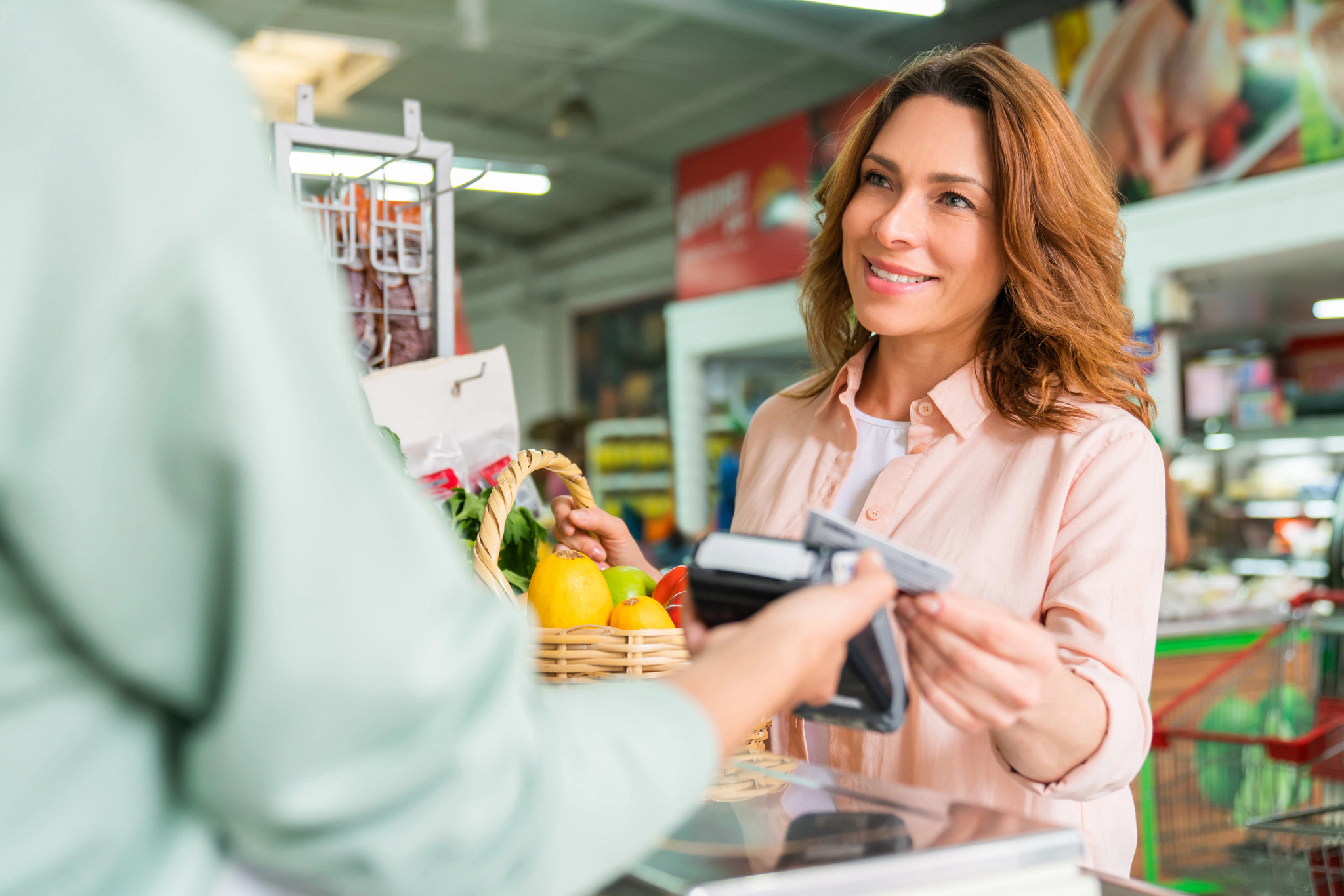 Customer shopping at the supermarket and making a contactless payment