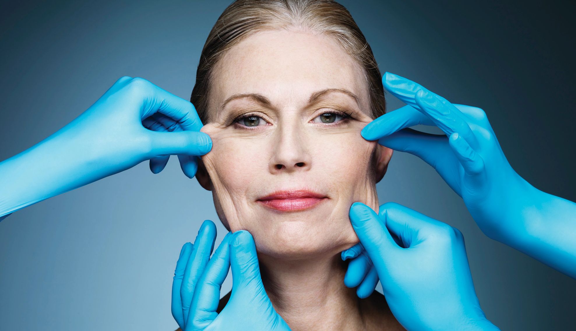 Visiting a Plastic Surgeon womans face being touched by gloved hands