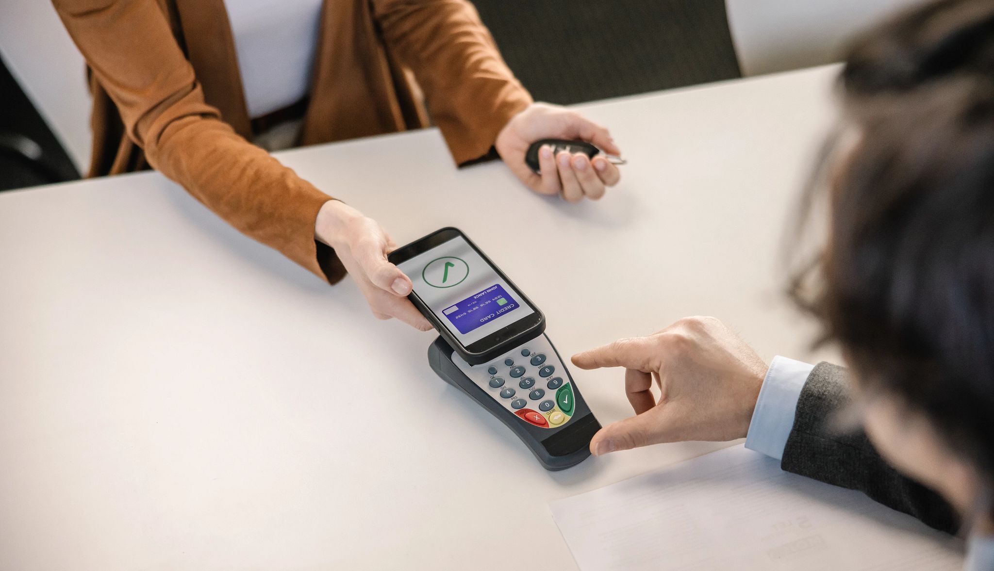 Smart Guide to Car Rentals a person paying using a credit card on their phone