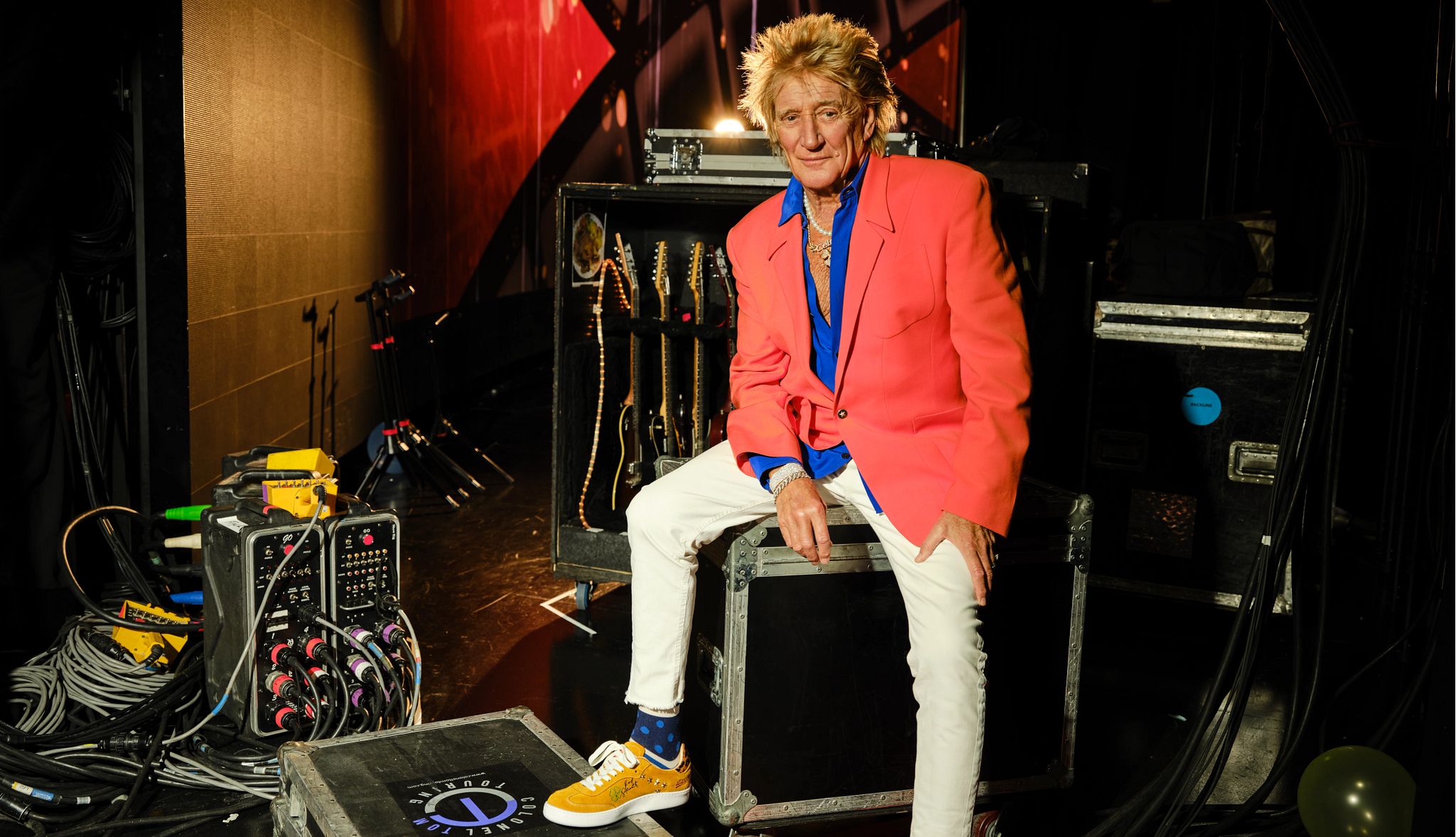 Rod Stewart: Still Sexy at 80 Rod Stewart, posing with crates of music equipment in a backstage area