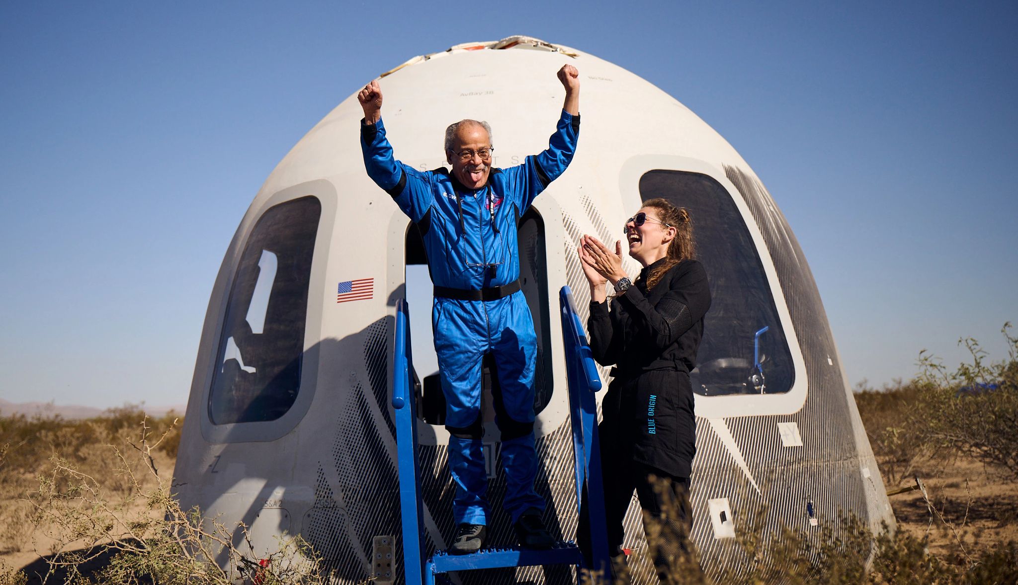Ed Dwight celebrating the ride of his life Astronaut Ed Dwight and crew member, elated after a successful spaceflight, exiting the spacecraft.