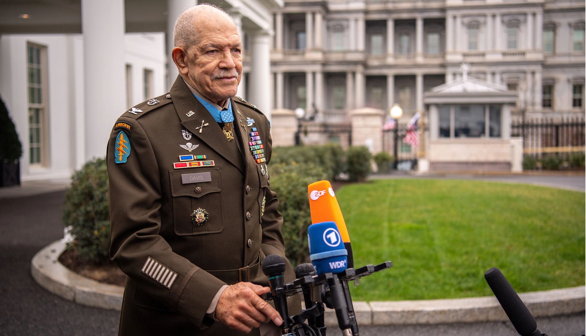 Medal of Honor Recipient Paris Davis paris davis, in military dress uniform, stands in front of news microphones