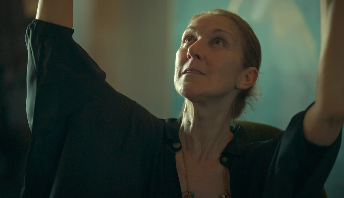 Celine Dion Celine Dion with her arms raised in the air in a scene from the Prime Video documentary I Am Celine Dion