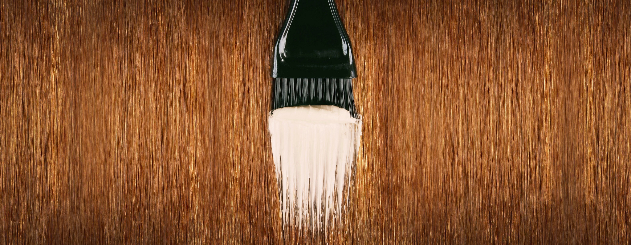 Red hair with brush applying hair dye