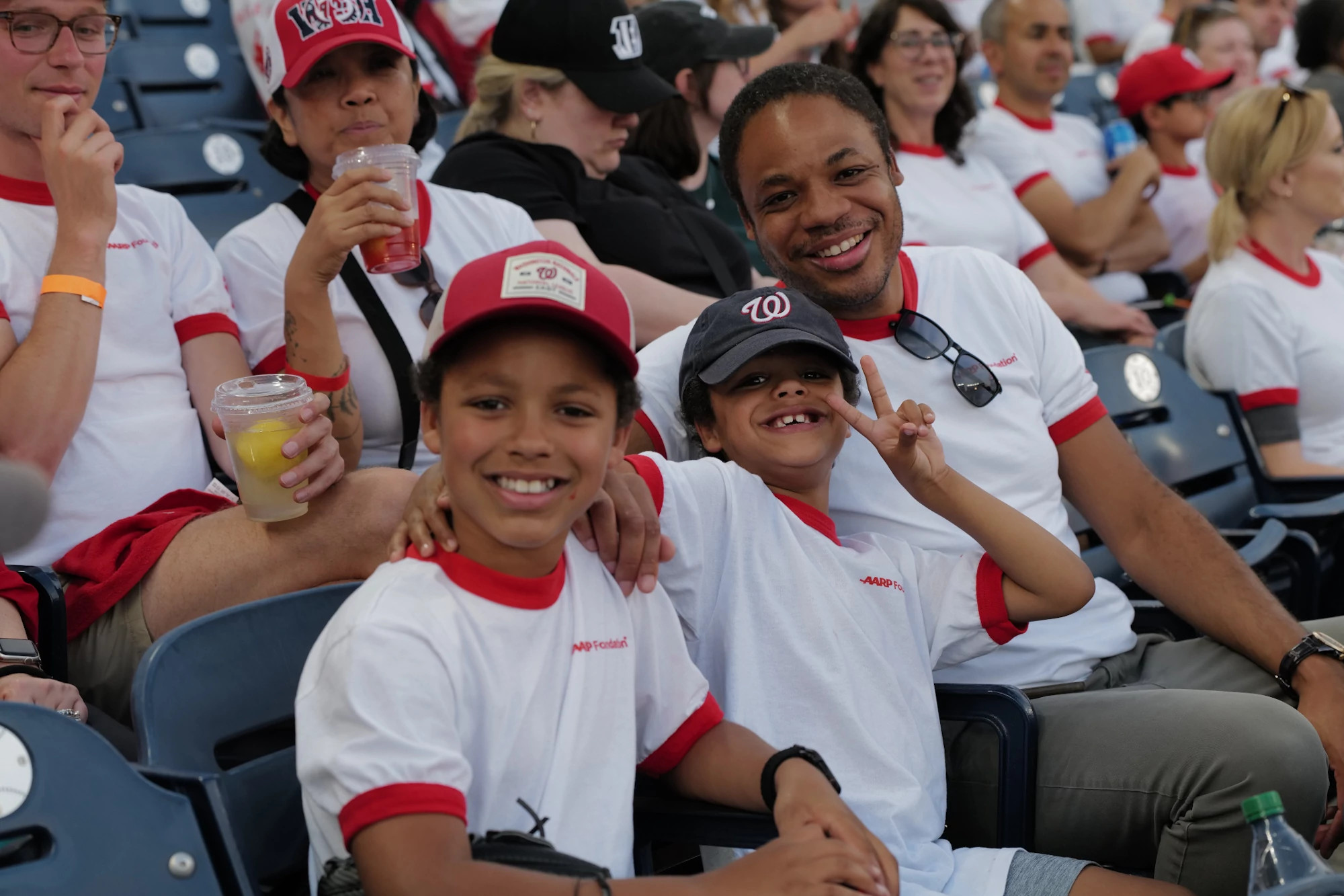 A photo shows AARP Foundation staff and guests cheereing on the Washington Nationals.