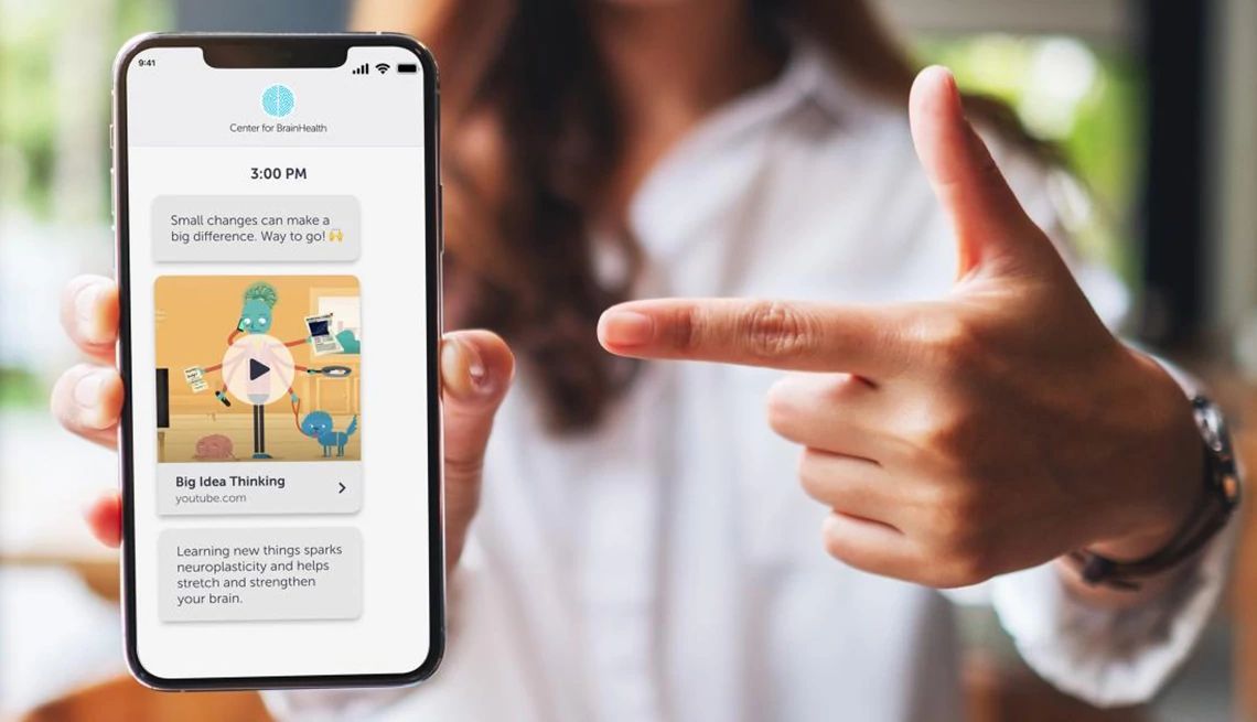 Learn and apply daily brain-healthy tips with the Center for BrainHealth A woman's hand pointing at the screen of a cell phone