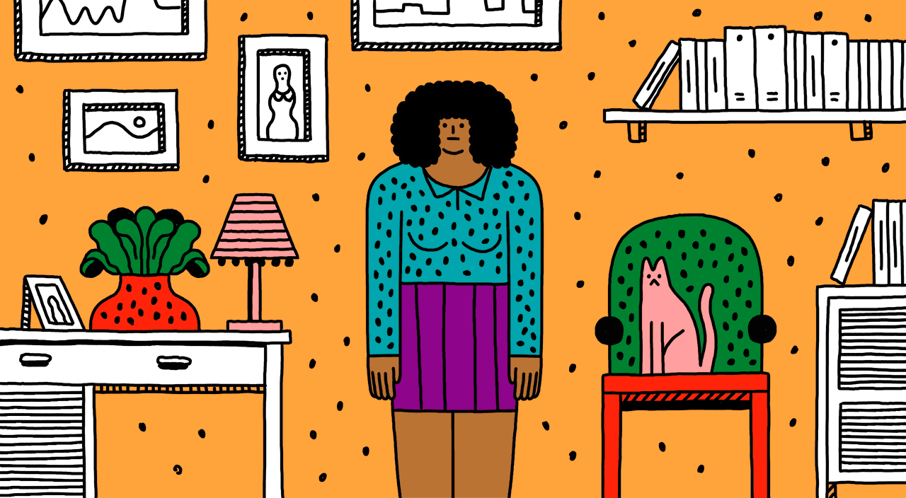 An older woman standing in a home living space with bookshelves, framed artwork, houseplants and a cat sitting in a chair.