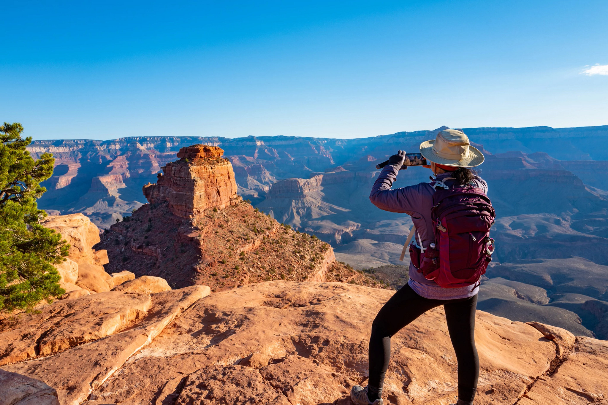 hiker taking a photo at the Grand Canyon
