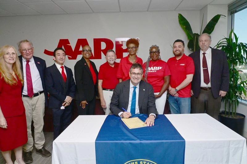 a group of aarp volunteers with governor meyer
