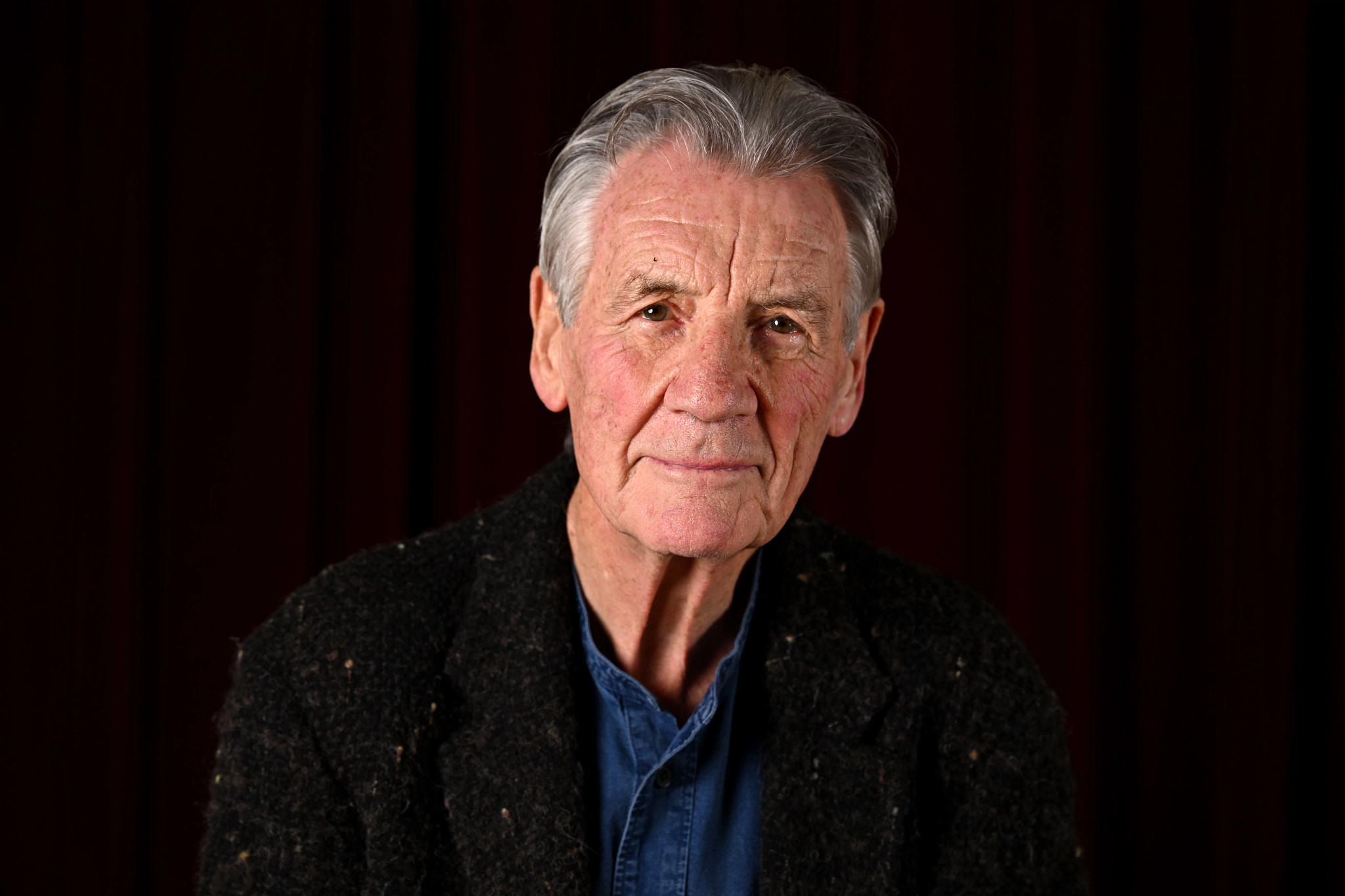 Michael Palin posing for a portrait.