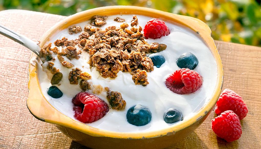 Protein may be good for you to have for breakfast A close-up view of a yogurt with berries and granola