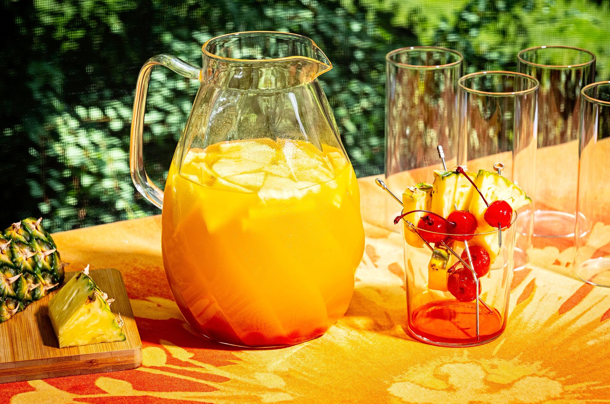 A Pineapple Martini is refreshing on a hot summer day a pitcher of Martini and empty glasses on a table