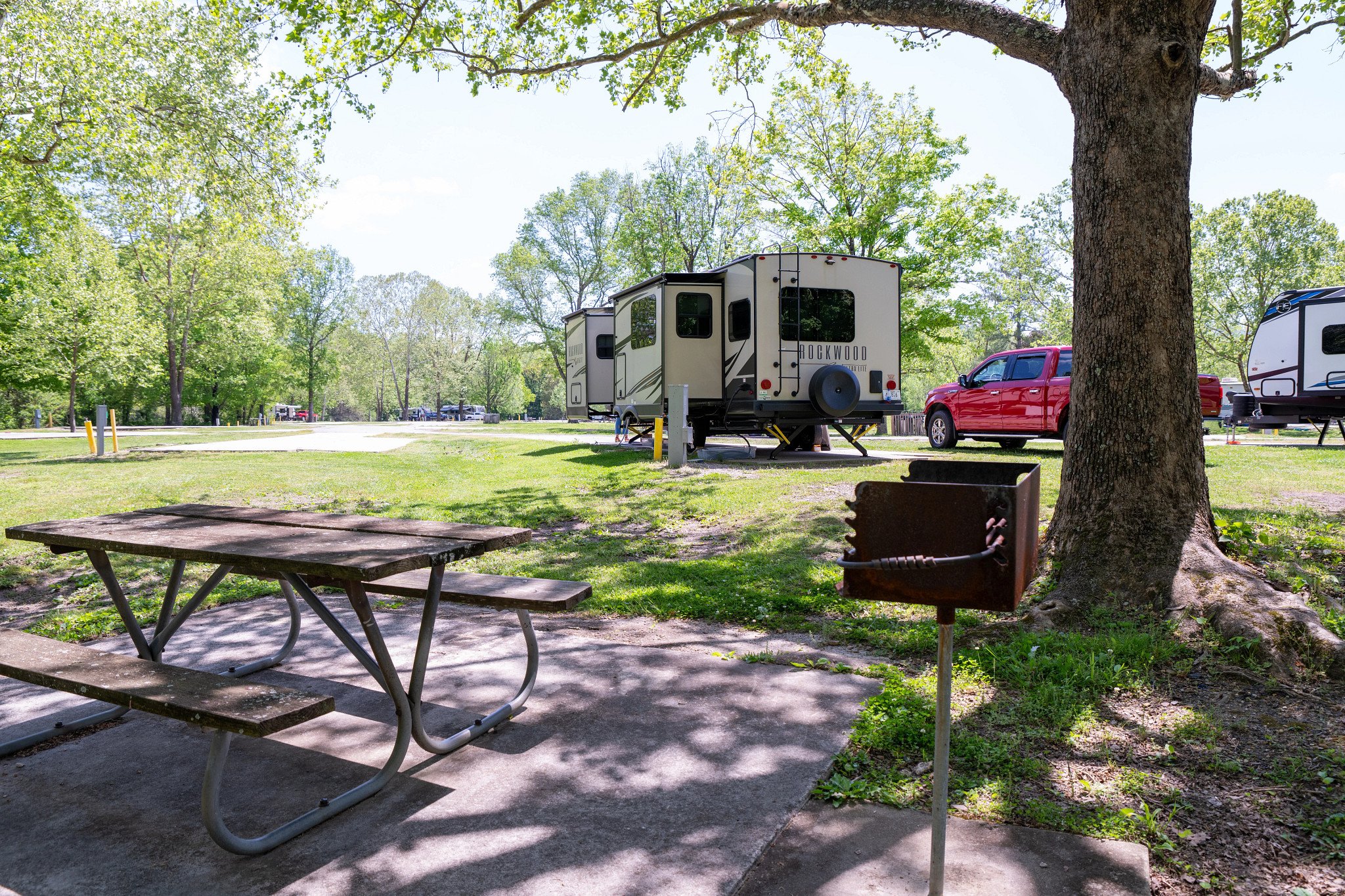a picnic table near an rv at a campground